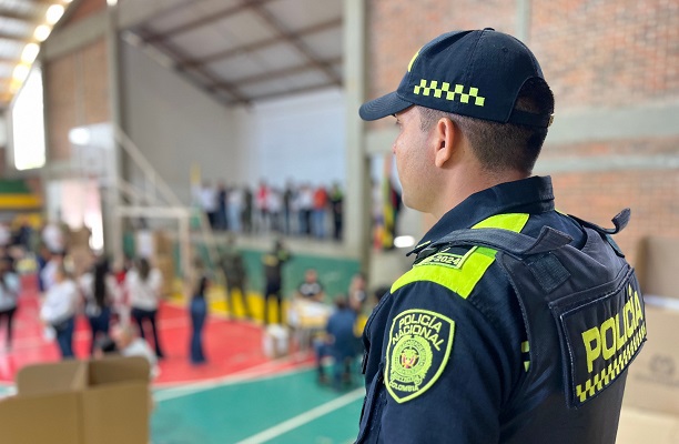 Uniformado de la Policía Nacional prestando seguridad al interior de un puesto de votación.